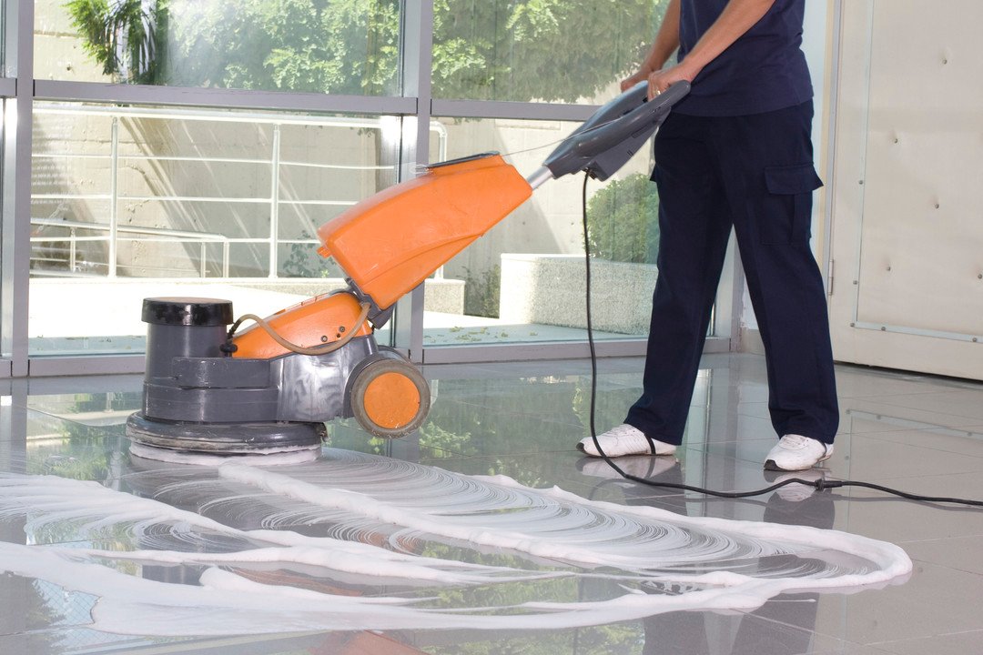 Cleaning the floor with machine